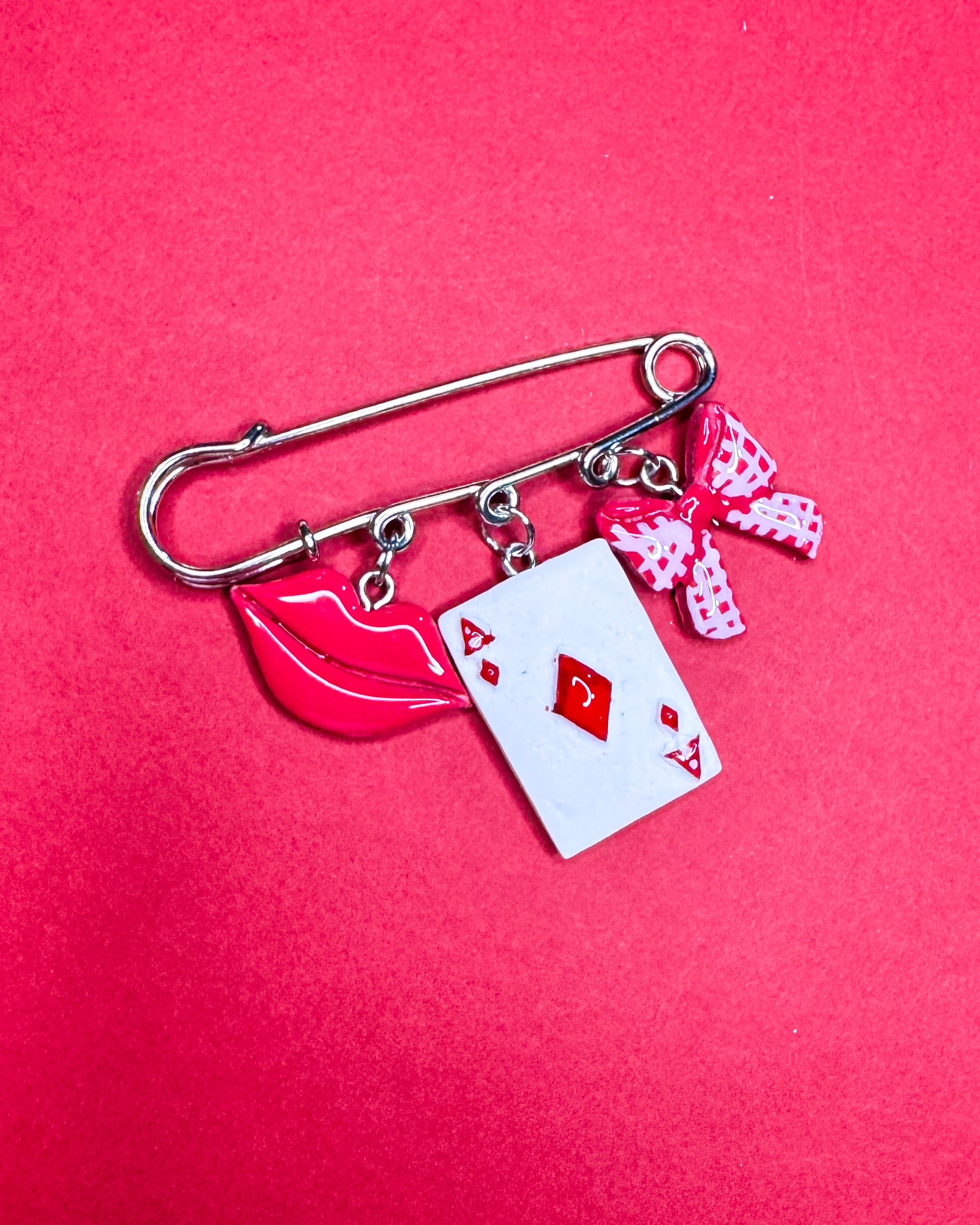 Beso ganador | Prendedor